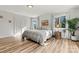 Bright bedroom with wood floors, windows, and neutral-toned furnishings at 3995 Burton Ln, Denver, NC 28037