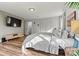 Cozy bedroom features wood flooring, and a modern mounted television at 3995 Burton Ln, Denver, NC 28037