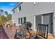 Deck area featuring wooden chairs, a dining table, and a grill for outdoor cooking at 3995 Burton Ln, Denver, NC 28037