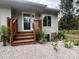 Charming home featuring a light gray exterior and a welcoming wood staircase leading to the front door at 3995 Burton Ln, Denver, NC 28037