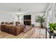 Inviting living room with a fireplace, large leather couch, and lots of natural light at 3995 Burton Ln, Denver, NC 28037