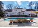 Large in-ground pool with stone water feature, lounge furniture, and deck at 4001 Carmel Acres Dr, Charlotte, NC 28226