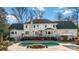 White brick home exterior featuring a large deck and kidney shaped pool at 4001 Carmel Acres Dr, Charlotte, NC 28226