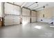 Spacious three car garage with white paneled doors and ample space at 4001 Carmel Acres Dr, Charlotte, NC 28226