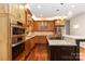 Gourmet kitchen with stainless steel appliances and wood cabinets at 4001 Carmel Acres Dr, Charlotte, NC 28226