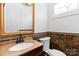 Chic powder room with ornate mirror, decorative stone walls and elegant fixtures at 4001 Carmel Acres Dr, Charlotte, NC 28226