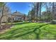 This spacious backyard features mature trees and a large lawn at 4004 Blossom Hill Dr, Matthews, NC 28104