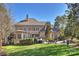 Expansive backyard with lush green lawn, patio, and elegant home exterior at 4004 Blossom Hill Dr, Matthews, NC 28104