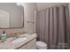 This bathroom features a granite vanity countertop, a large mirror, and a shower with a curtain at 4004 Blossom Hill Dr, Matthews, NC 28104