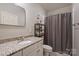 This bathroom features a vanity with a granite countertop, a large mirror and a shower with a curtain at 4004 Blossom Hill Dr, Matthews, NC 28104