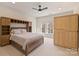 This bedroom features a custom wood bed frame with built-in storage, a ceiling fan and natural light at 4004 Blossom Hill Dr, Matthews, NC 28104