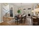 Inviting dining room with a view of the staircase and a large wood table with seating at 4004 Blossom Hill Dr, Matthews, NC 28104