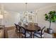 Bright dining area featuring a hardwood floors, chandelier, and access to the exterior patio at 4004 Blossom Hill Dr, Matthews, NC 28104