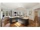 Gourmet kitchen featuring island with gas cooktop, white countertops, and hardwood floors at 4004 Blossom Hill Dr, Matthews, NC 28104