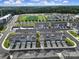 A panoramic aerial view of the community features townhomes, sports facilities, and pond at 432 Burr St, Indian Trail, NC 28079