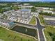 Beautiful aerial view of townhomes surrounding a tranquil pond with a fountain feature at 432 Burr St, Indian Trail, NC 28079