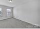 Bright bedroom with neutral walls, carpet flooring, and a window at 432 Burr St, Indian Trail, NC 28079