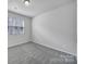 Well-lit bedroom with neutral carpet and a window offering natural light at 432 Burr St, Indian Trail, NC 28079