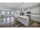 Open kitchen featuring a large island with pendant lighting and hardwood floors at 432 Burr St, Indian Trail, NC 28079