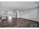 Open-concept living room with wood floors and view of the staircase and kitchen at 432 Burr St, Indian Trail, NC 28079