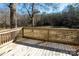 A wooden back deck with railing provides the perfect place to enjoy the yard at 4428 Turkey Ln, Rock Hill, SC 29730