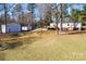 Expansive backyard with well-kept lawn featuring a detached garage, storage building and wooden deck at 4428 Turkey Ln, Rock Hill, SC 29730