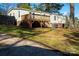 View of backyard with a deck, mature trees and a small storage shed at 4428 Turkey Ln, Rock Hill, SC 29730