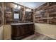 A bathroom with a wood accent wall and a double sink vanity with marble countertop at 4428 Turkey Ln, Rock Hill, SC 29730