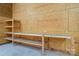 Plywood walled garage interior with concrete floor, shelving, and workbench at 4428 Turkey Ln, Rock Hill, SC 29730