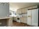 View of the kitchen featuring all-white appliances, light cabinets, and wooden flooring at 4428 Turkey Ln, Rock Hill, SC 29730