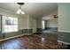 Open living room with wood laminate flooring, and wainscoting, and a neutral color palette at 4428 Turkey Ln, Rock Hill, SC 29730