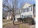 Townhome exterior showcasing a tree and manicured shrubs at 6019 Queens Walk Ct, Indian Land, SC 29707