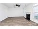 Living room with hardwood floors, fireplace, and access to patio at 6019 Queens Walk Ct, Indian Land, SC 29707