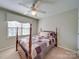 Cozy bedroom with a four-poster bed and window at 6020 Havencrest Nw Ct, Concord, NC 28027