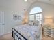 Cozy bedroom with arched window and ceiling fan at 6020 Havencrest Nw Ct, Concord, NC 28027