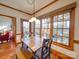 Bright breakfast nook with wood table and bench, offering backyard views at 6020 Havencrest Nw Ct, Concord, NC 28027