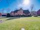 Two-story brick home with a spacious lawn and landscaping at 6020 Havencrest Nw Ct, Concord, NC 28027