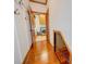 Long hallway showcasing hardwood floors and access to laundry and stairs at 6020 Havencrest Nw Ct, Concord, NC 28027