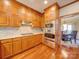 Kitchen with wood cabinets, stainless steel appliances, and hardwood floors at 6020 Havencrest Nw Ct, Concord, NC 28027