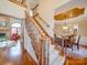 Elegant staircase with wood railing and carpet runner at 6020 Havencrest Nw Ct, Concord, NC 28027