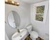 Updated half bathroom with pedestal sink and toilet at 7401 Limerick Dr, Charlotte, NC 28270