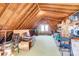 Spacious attic with exposed beams, carpeting, and natural light from the windows at 7707 Ritter Dr, Charlotte, NC 28270