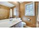 Cozy bathroom featuring a shower with tiled walls, single sink vanity, and neutral wall color at 7707 Ritter Dr, Charlotte, NC 28270