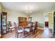 Formal dining room with hardwood floors, chandelier, and ample seating for Gathering gatherings at 7707 Ritter Dr, Charlotte, NC 28270