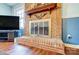 Close up of brick fireplace with detailed mantle, hearth, and vintage glass screen, adding a classic touch at 7707 Ritter Dr, Charlotte, NC 28270