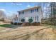 Two-story home featuring blue shutters, brick chimney and entrance, and well-maintained landscaping at 7707 Ritter Dr, Charlotte, NC 28270