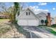 Two car attached garage featuring a paved driveway and neutral exterior at 7707 Ritter Dr, Charlotte, NC 28270