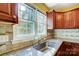 Close up of Kitchen featuring stainless steel sink, tile backsplash and granite countertops at 7707 Ritter Dr, Charlotte, NC 28270