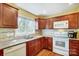 Spacious kitchen with stainless steel appliances, light countertops, and tile backsplash at 7707 Ritter Dr, Charlotte, NC 28270