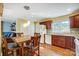 Eat-in kitchen featuring stainless steel appliances, wood cabinets, and tile backsplash at 7707 Ritter Dr, Charlotte, NC 28270